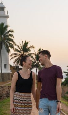 Young,Couple,Walking,Near,The,Sea,On,Sunset